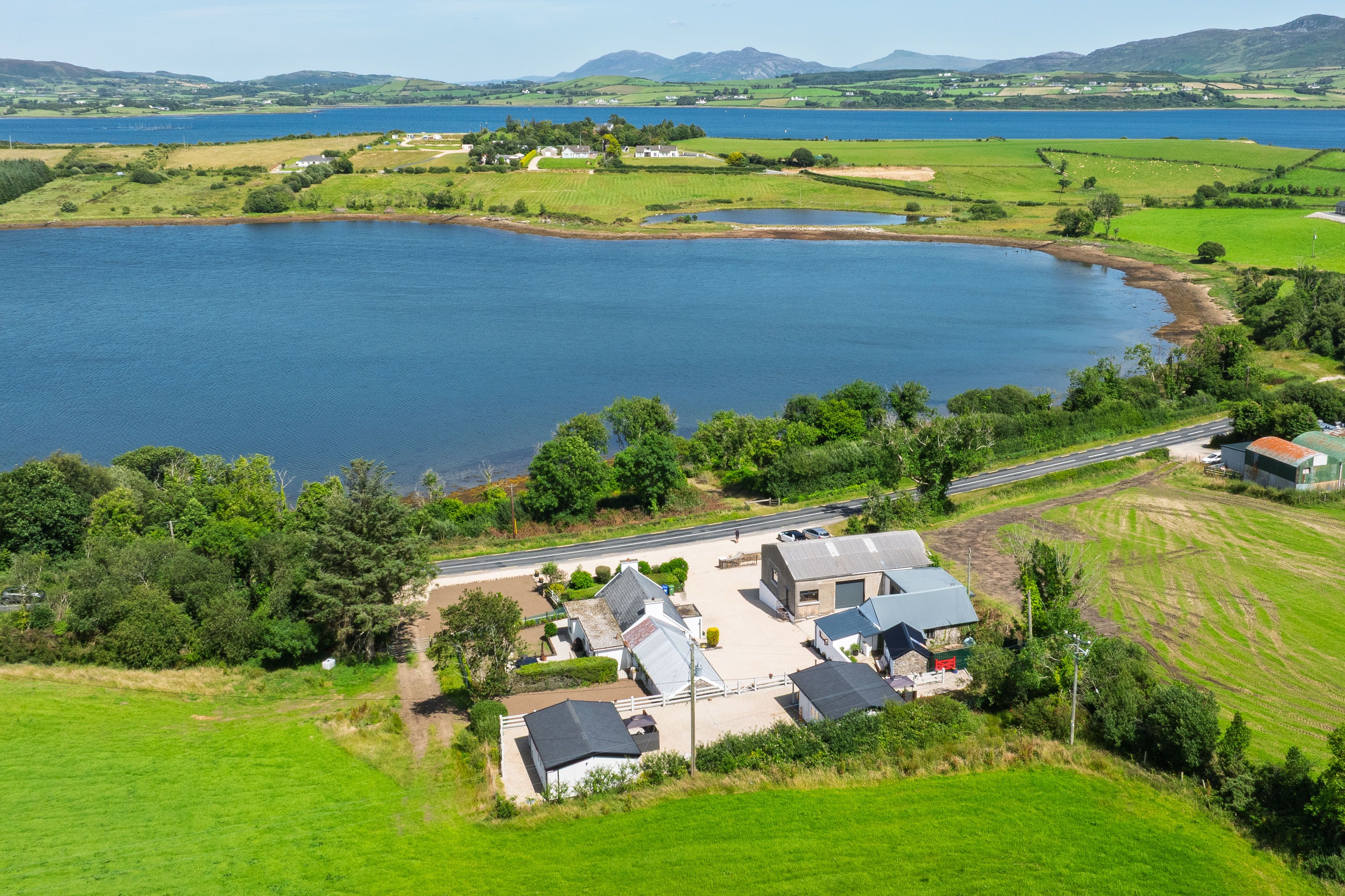 Wide aerial across the property to Mulroy Bay and the far mountains