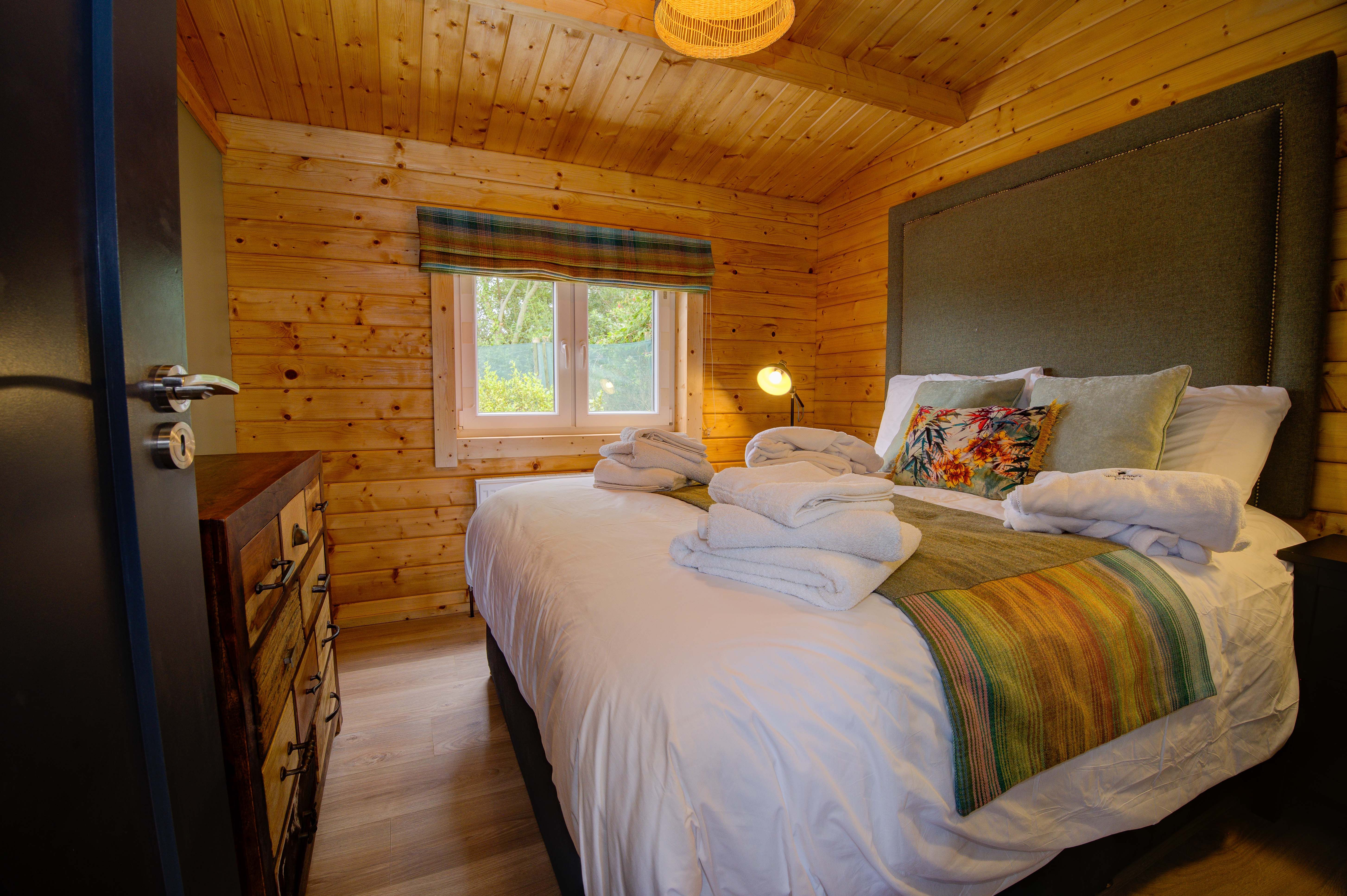 Rae’s bedroom from the doorway, the tweed headboard along the wall