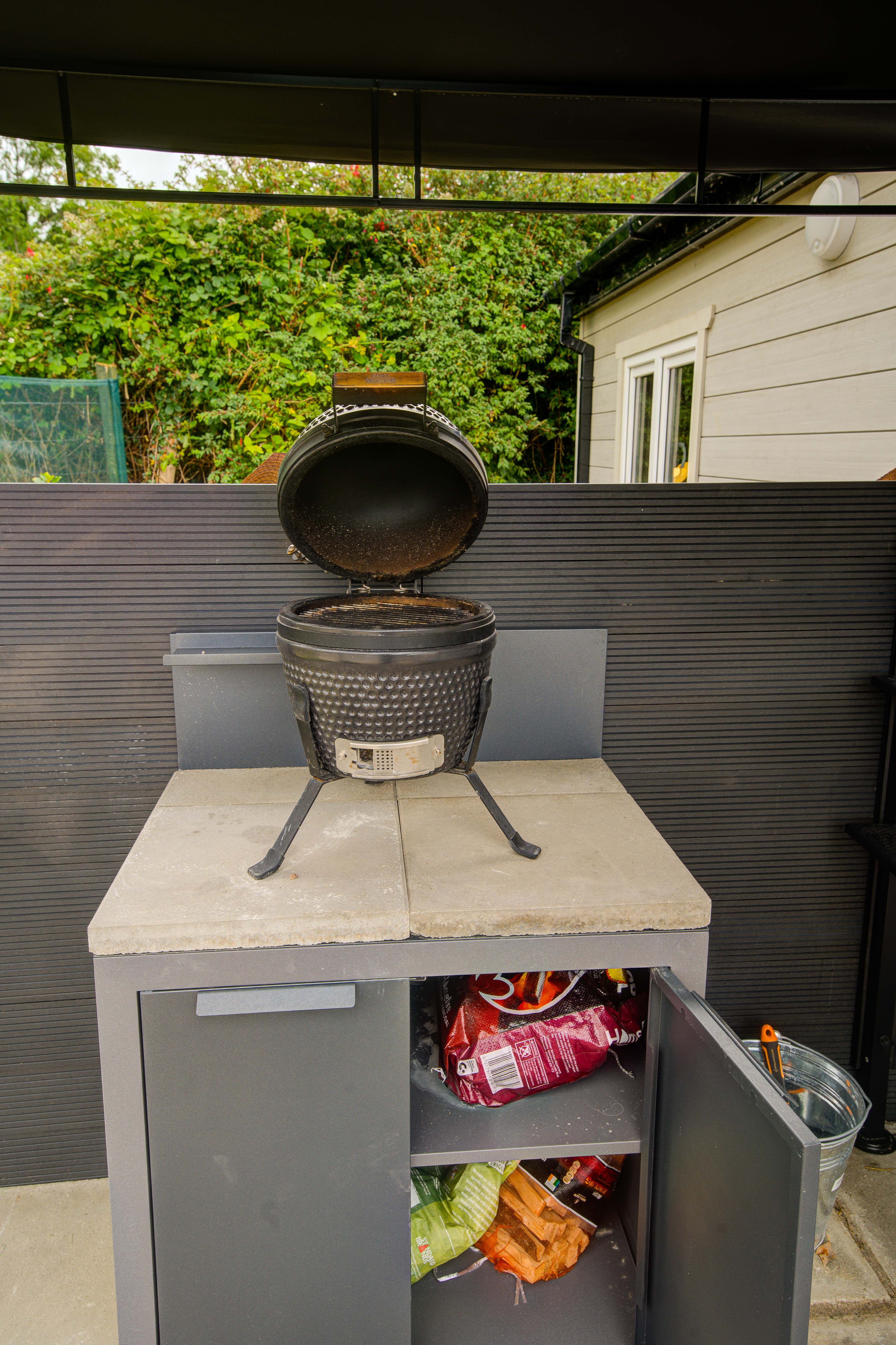 The ceramic-egg kamado grill at Rae’s Cabin, lid open