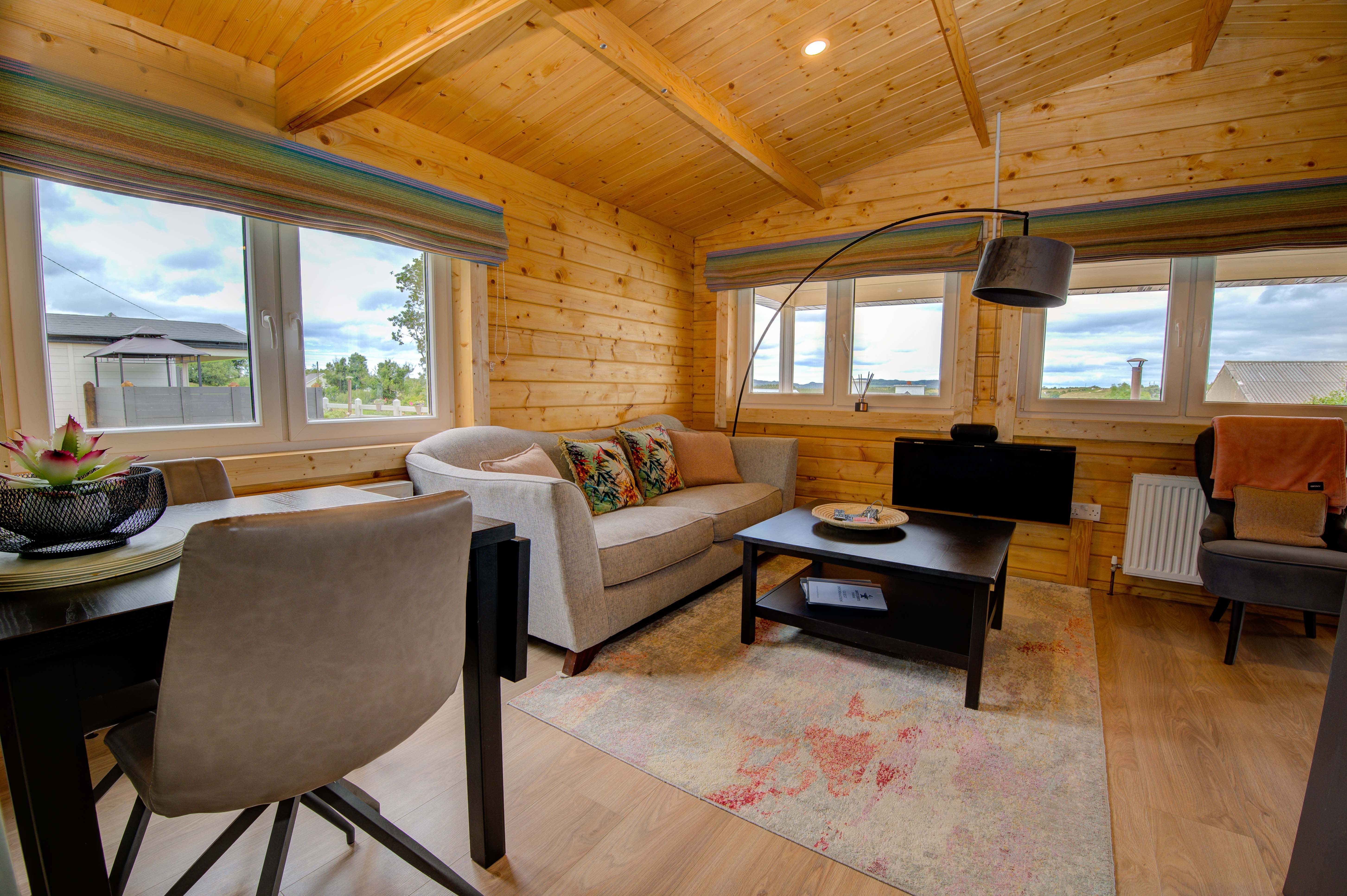 Rae’s open-plan living room under the honey-pine vaulted ceiling