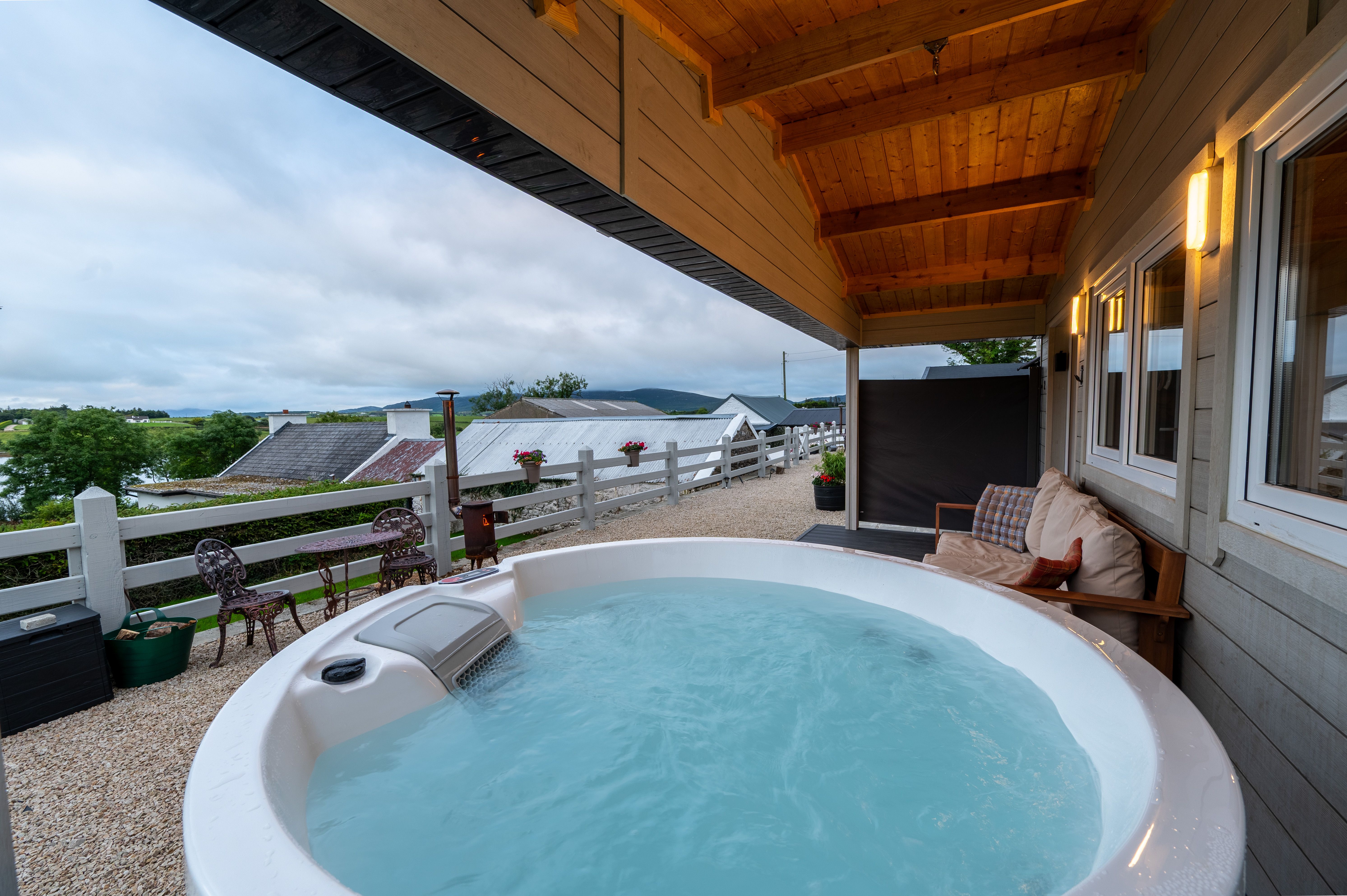 Wide view from Cabin One's hot tub across the outbuildings to Mulroy Bay
