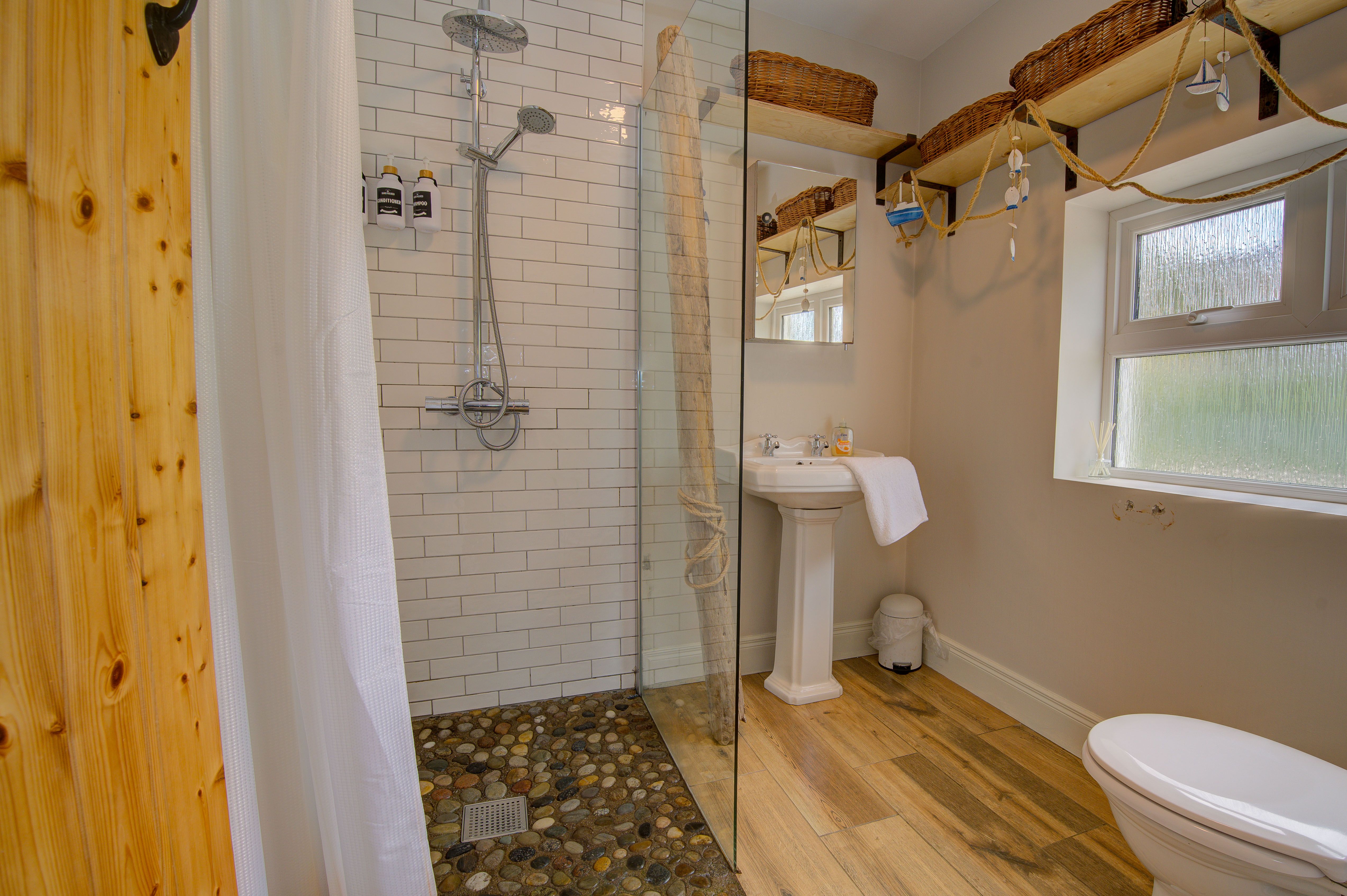 The cottage bathroom with walk-in rain shower and pebble floor