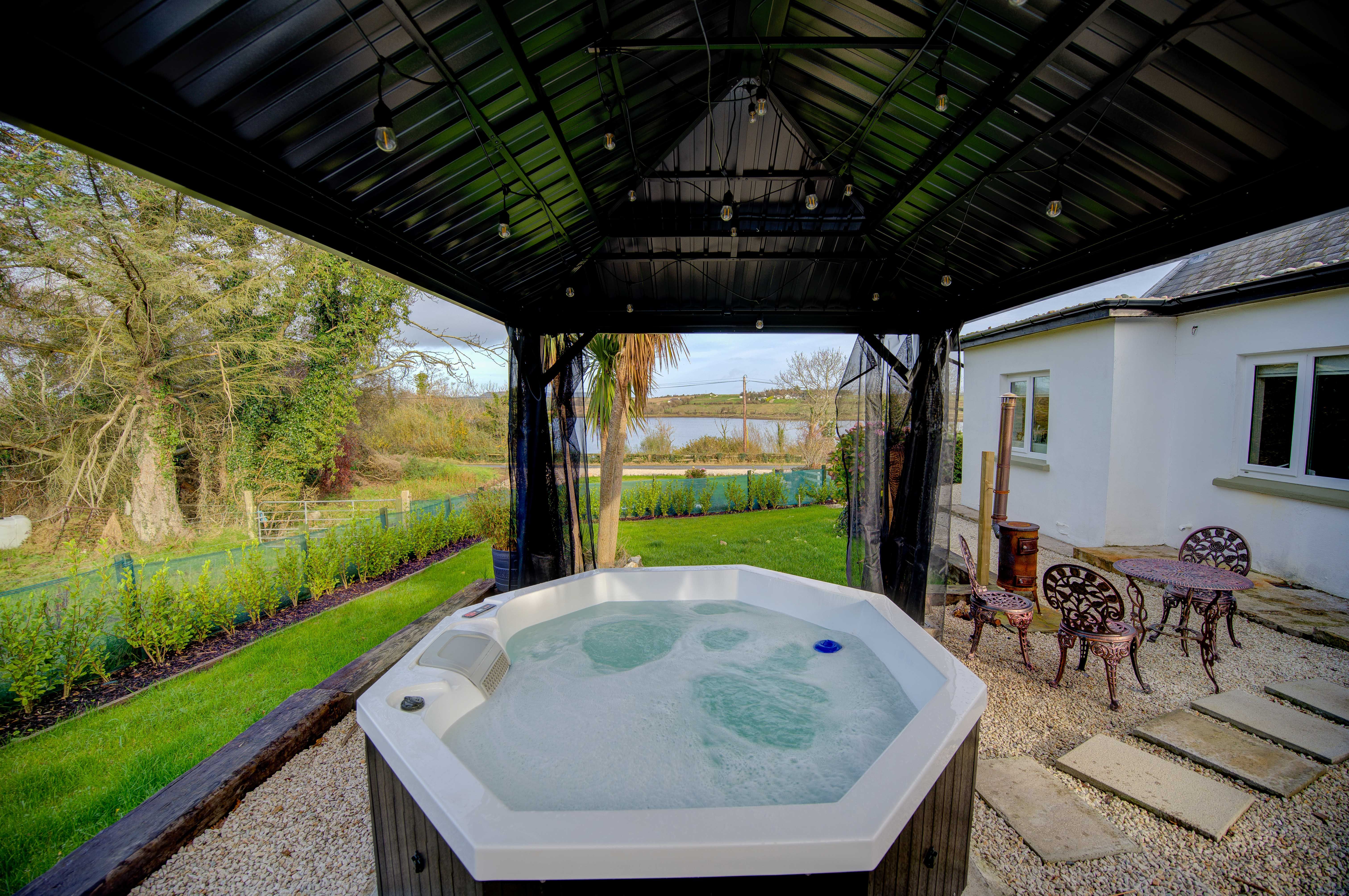 The cottage hot tub in the gazebo, bubbling, looking out over Mulroy Bay