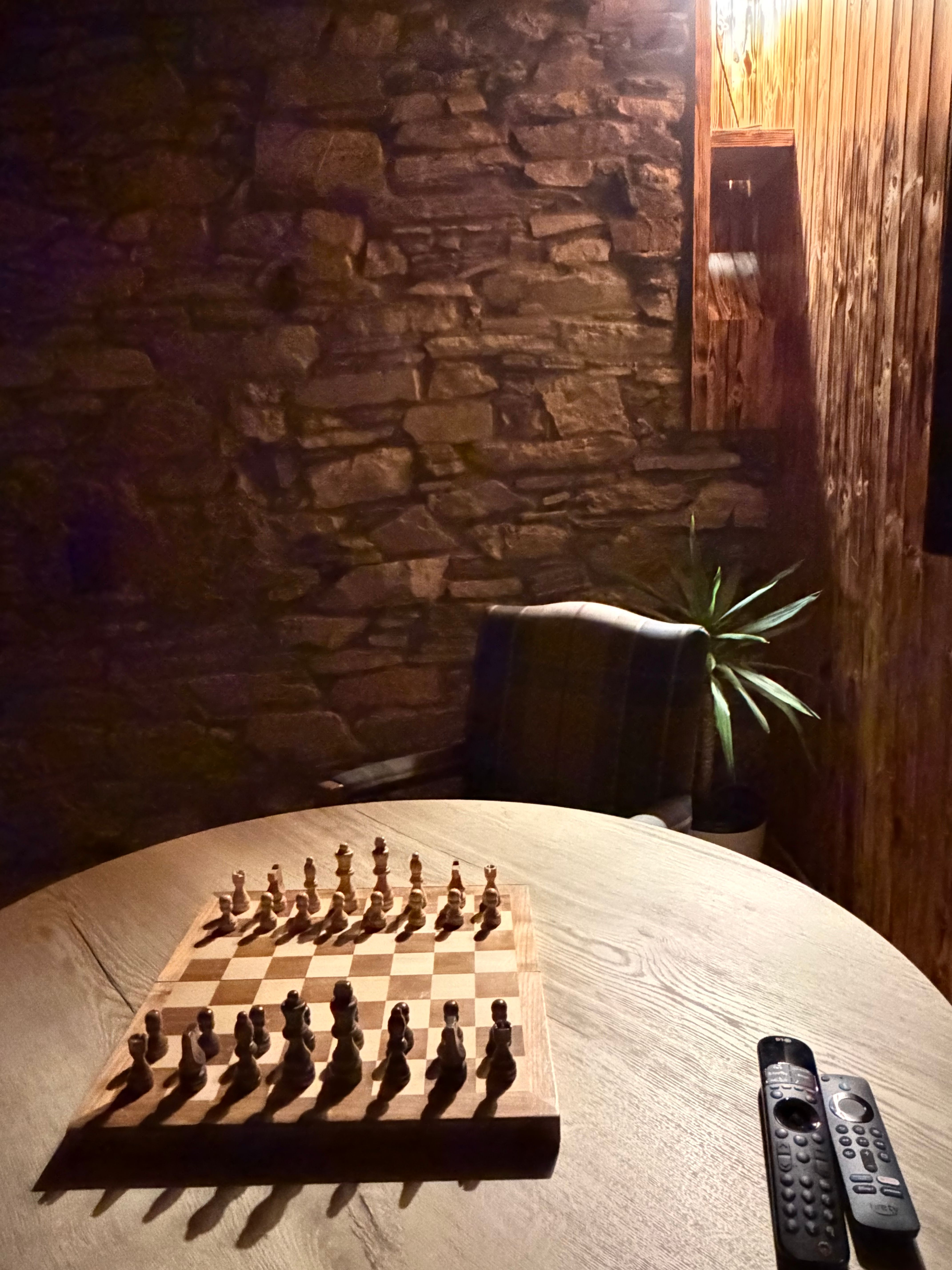 The chess board set against the dry-stone feature wall.