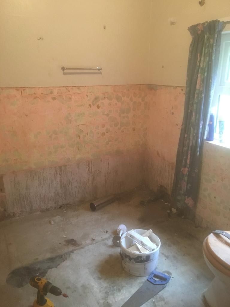 The old bedroom at the far end of the cottage, stripped back — the room that would become the kitchen.