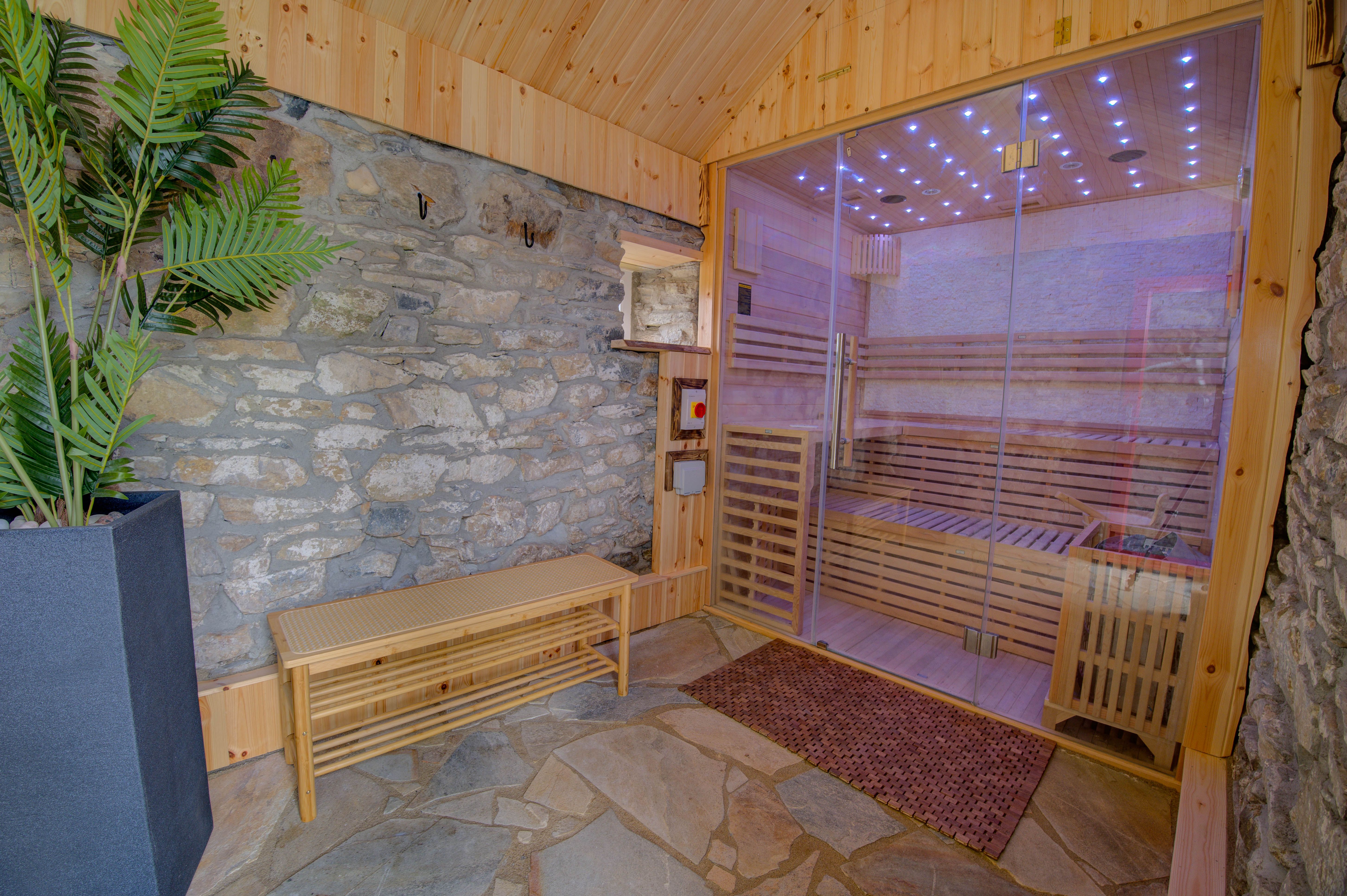 Inside the hot-stone sauna, the fibre-optic starfield ceiling seen through the glass